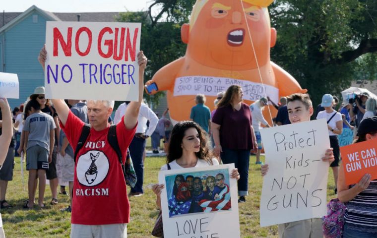 Protesters gathered, just as they had at Trump's earlier stop in Dayton, Ohio, where nine people died in a separate mass shooting over the weekend.