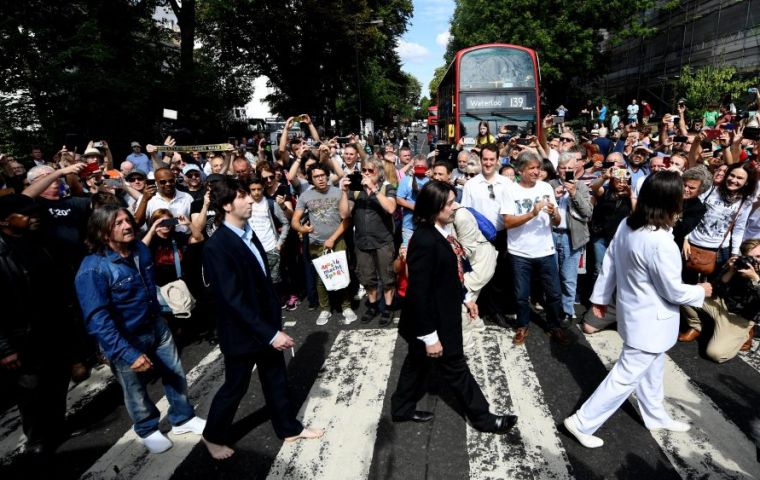 On Thursday, the Beetle was back in position while traffic crawled along the crowded street as dozens of fans paraded on the black and white painted crossing