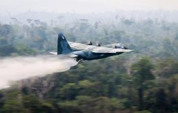 The Defense Ministry video, showed a military plane pumping thousands of liters of water out of two giant jets as it passed through clouds of smoke