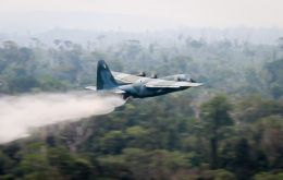 Two C-130 Hercules aircraft carrying thousands of liters of water on Sunday began dousing fires devouring chunks of the world's largest rainforest