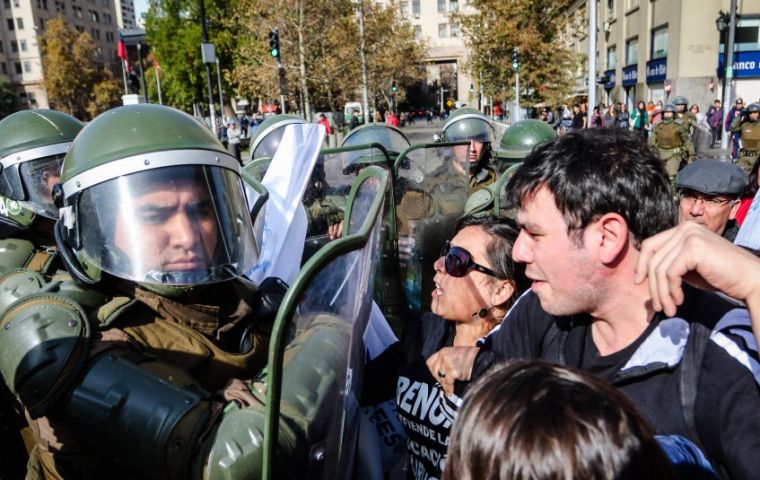 The Carabineros fighting demonstrators in the streets of Santiago de Chile 