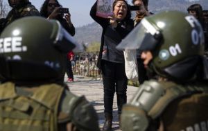 Police at first protectively lined the route as marchers proceeded to a memorial to Pinochet's victims at the city's General Cemetery.