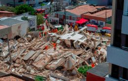 The building in the northeastern city of Fortaleza collapsed without warning at about 10:30 a.m., cloaking the surrounding neighborhood in smoke and debris