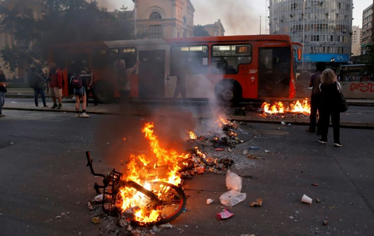 The protest by students began Monday when hundreds of students mobbed several stations in Santiago, jumping over or dipping under turnstiles to protest fares