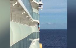 It was of a woman standing on a balcony railing of her stateroom on one of the world's largest cruise ships - posing for a selfie.