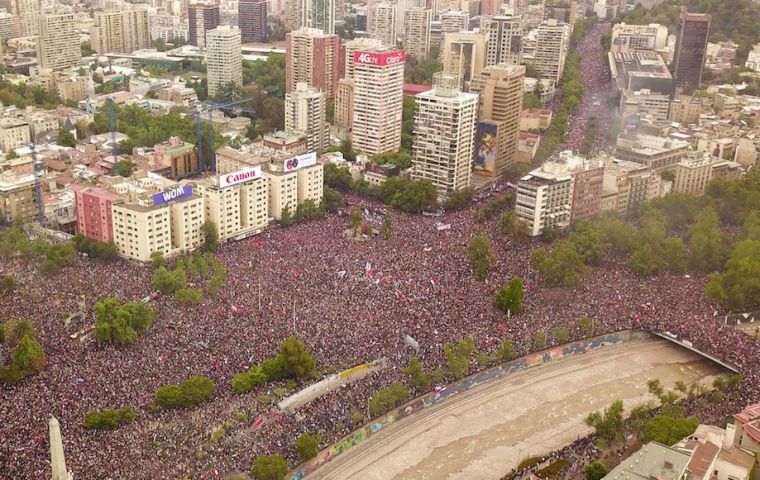 Protesters waving national flags, dancing, banging pots with wooden spoons and bearing placards urging political and social change streamed through the streets