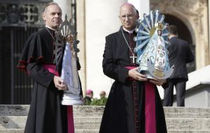 Bishop Paul Mason of the UK Armed Forces (L) and Bishop Santiago Olivera of the Argentine Armed Forces hold statues of Our Lady of Lujan in St. Peter's Square, Oct 30, 2019.