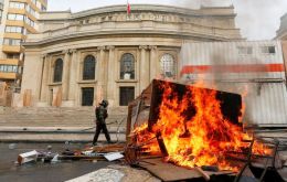 Hooded protesters looted a Roman Catholic church in Santiago near the main site of the demonstration. They dragged images of Jesus and burned them.
