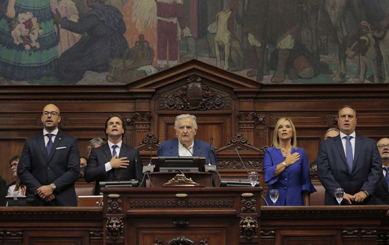 Lacalle Pou taking the oath of office in the Parliament along with most voted senator, José Mujica