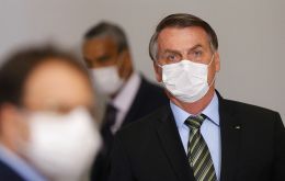 With criticism mounting, Bolsonaro held a news conference with ministers - all wearing masks - to announce emergency measures to buttress the economy