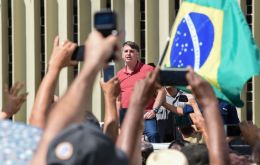 Bolsonaro, (not wearing a face mask), addressed a crowd of a few hundred in Brasilia, many of them wearing Brazil's yellow-and-green soccer jersey.