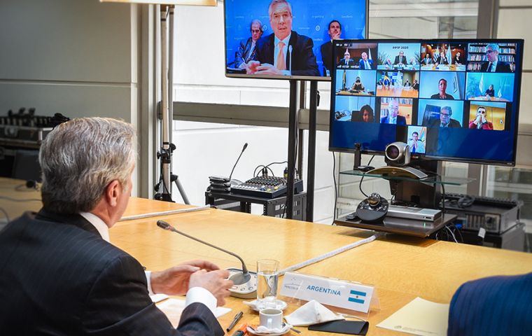 Argentine president Alberto Fernández next to foreign minister Felipe Solá during the video summit  