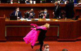Wearing a face mask and a pink shawl streaming behind her, Ms Pamela Jiles sprinted past bemused senior ministers in president Piñera's administration 