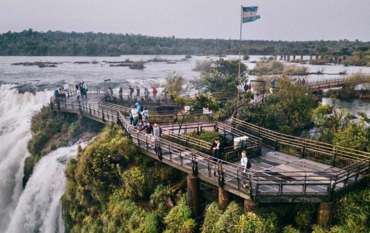 Tourists on a viewpoint over the Iguazu Falls on the Argentine side.
