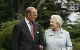 Buckingham Palace released a photograph of a smiling monarch and her husband looking at a card made by her great-grandchildren 