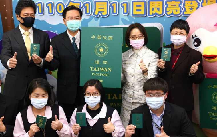 Taiwan foreign minister Joseph Wu and a mascot pose with models of the new Republic of China passport cover at its launching in Taipei 