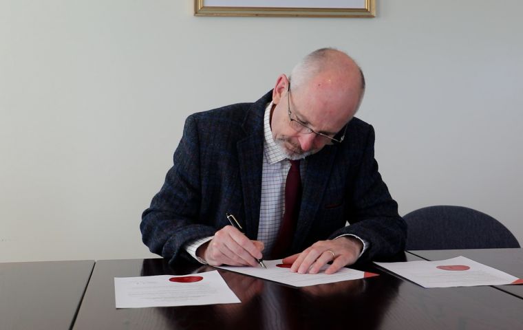 Governor Phillips CBE signs the writ for elections next November