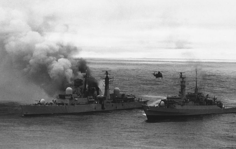 A Sea King hovering off HMS Sheffield's stern during rescue operations to save the crew of the ship 
