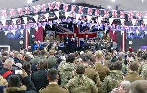 An overview of the packed City Hall covered in Union Jack and Falklands' flags 