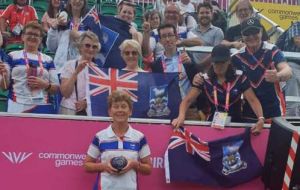 Daphne “stands” with a group of fans with Falklands' flags following her win