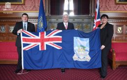 MLAs Leona Roberts and Mark Pollard with Sir Richard Hoyle and a Falklands Flag 