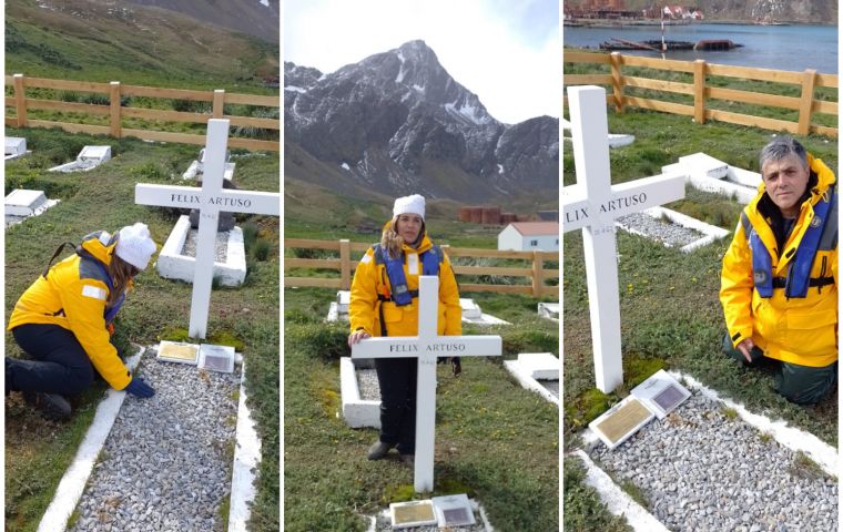 Artuso children and ex members of submarine ARA Santa Fe honor his grave covered with an Argentine flag at Grytviken cemetery 