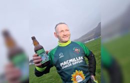 Gary McKee, 53, completed his 365th marathon in as many days under the rain in his native Cumbria, in northwest England on Sunday.