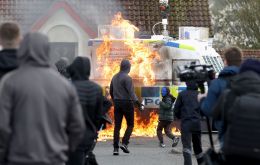 A media photograph showed four young people in the mainly Irish nationalist area throwing petrol bombs at an armored police vehicle, which was covered in flames on one sidezz