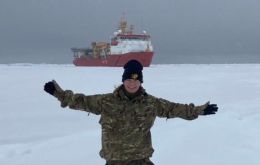 Chef Heidi Sermulins in Antarctica with HMS Protector in the background