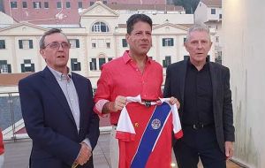 The two lawmakers from the Falklands present Chief Minister Fabian Picardo with a Falklands national soccer team vest   