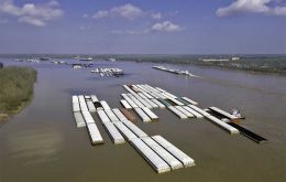 Barges along the Mississippi must travel to ports carrying less grain because of insufficient draft