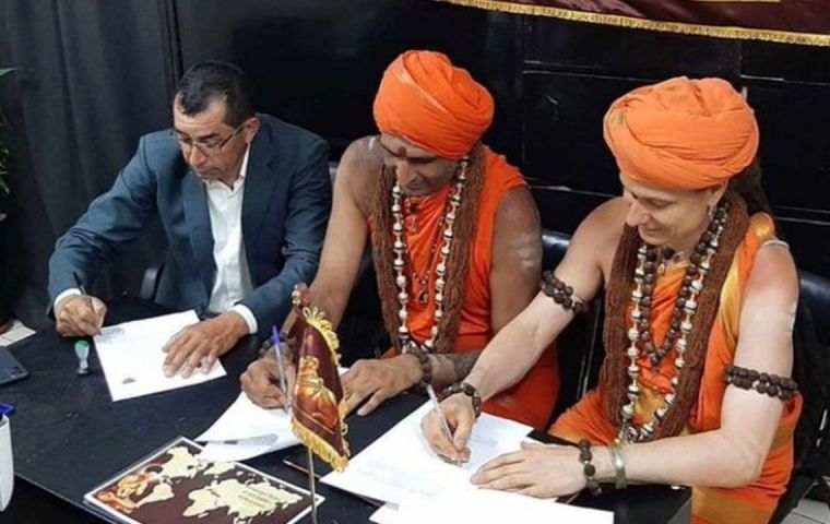 Two men dressed in orange native costumes have been going around public offices for a few months in Paraguay