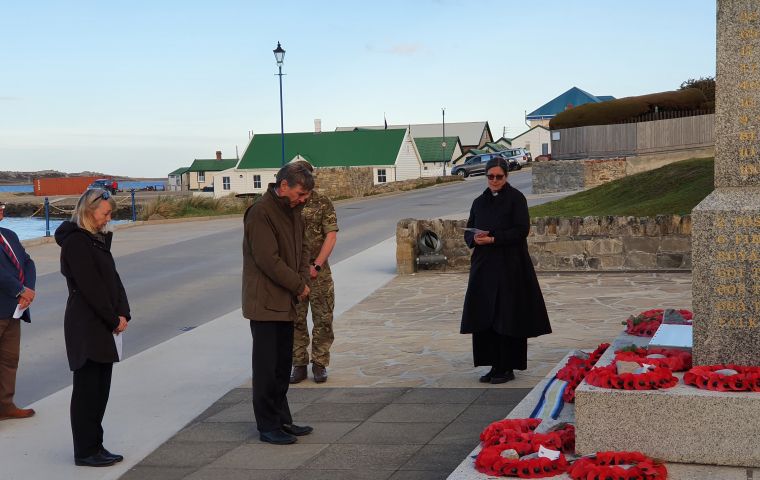 At the Liberation Memorial minister Rutley bows for a minute of silence