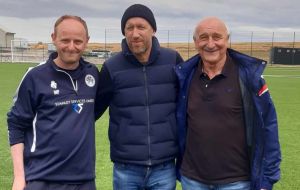 The former Chelsea coach next to Mike Summers (R) president of the Falklands Sports Council and Mike Poole Football Club Youth coach 